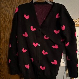 Black cardigan with pink hearts